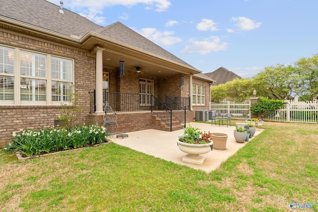 exterior space with cooling unit, a patio area, ceiling fan, and fence