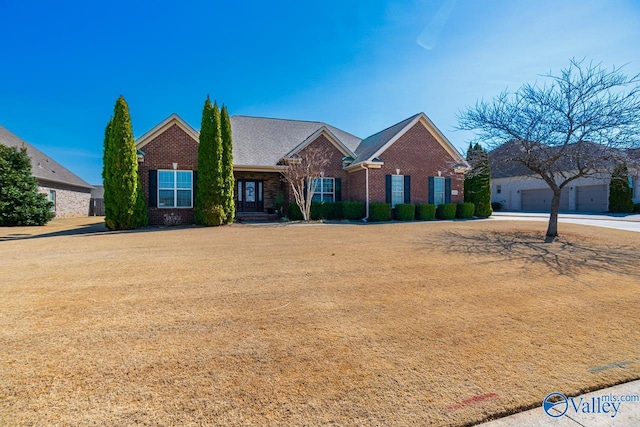 view of front of house with brick siding and a front yard