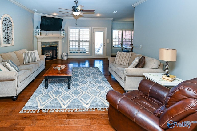 living room with ceiling fan, ornamental molding, recessed lighting, a fireplace, and wood finished floors