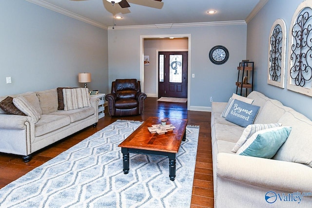 living area featuring baseboards, wood finished floors, a ceiling fan, and crown molding