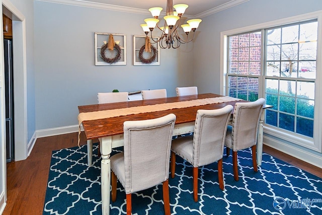 dining area featuring a notable chandelier, dark wood-style flooring, baseboards, and ornamental molding