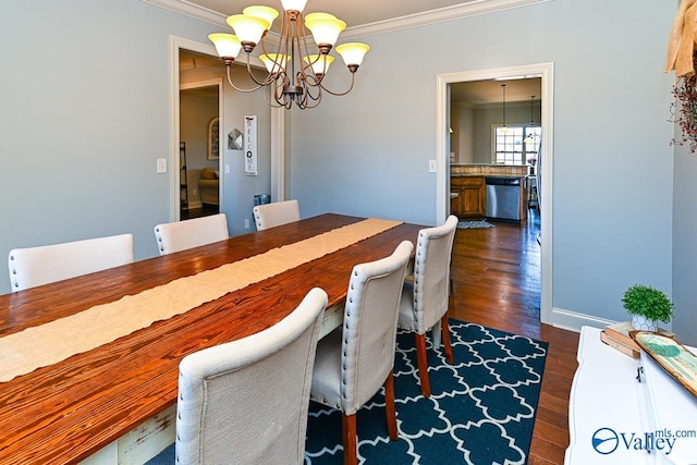 dining area with dark wood-type flooring, baseboards, crown molding, and an inviting chandelier