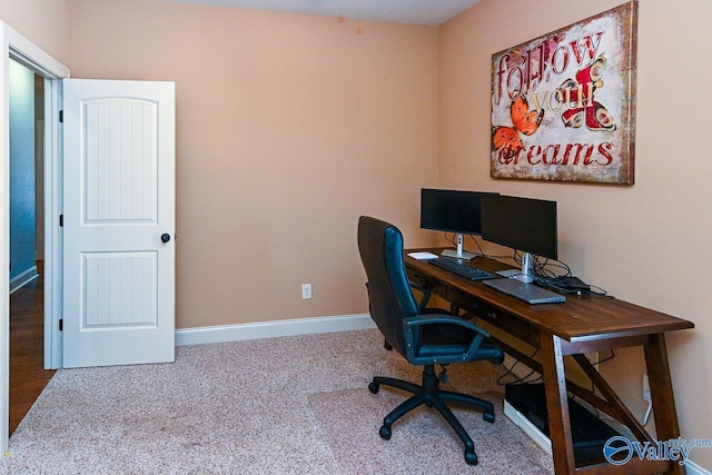 carpeted office featuring baseboards