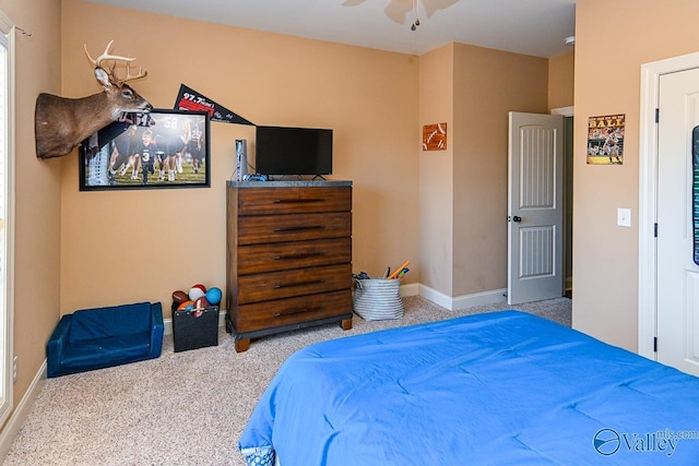 bedroom featuring carpet and baseboards