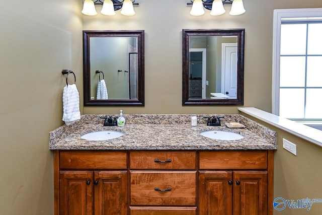 full bath featuring double vanity and a sink