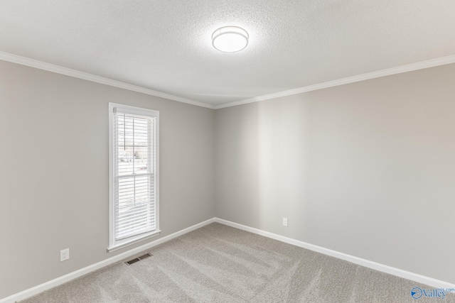 spare room featuring light carpet, a textured ceiling, visible vents, and baseboards