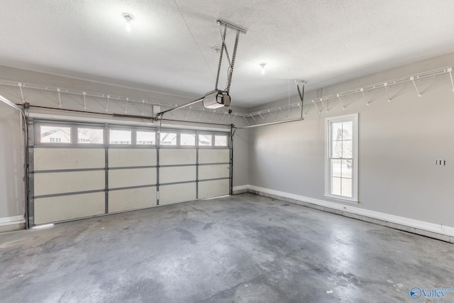 garage featuring a garage door opener and baseboards