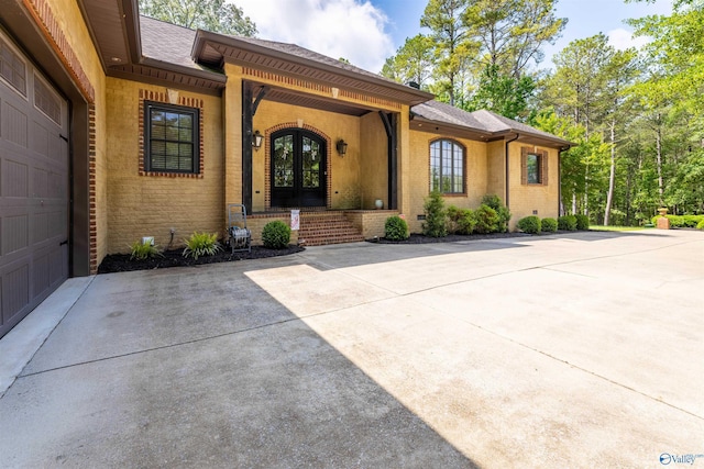 1805 Sibert Dr, Glencoe, AL 35905 - doorway to property with brick siding, french doors, roof with shingles, driveway, and a porch
