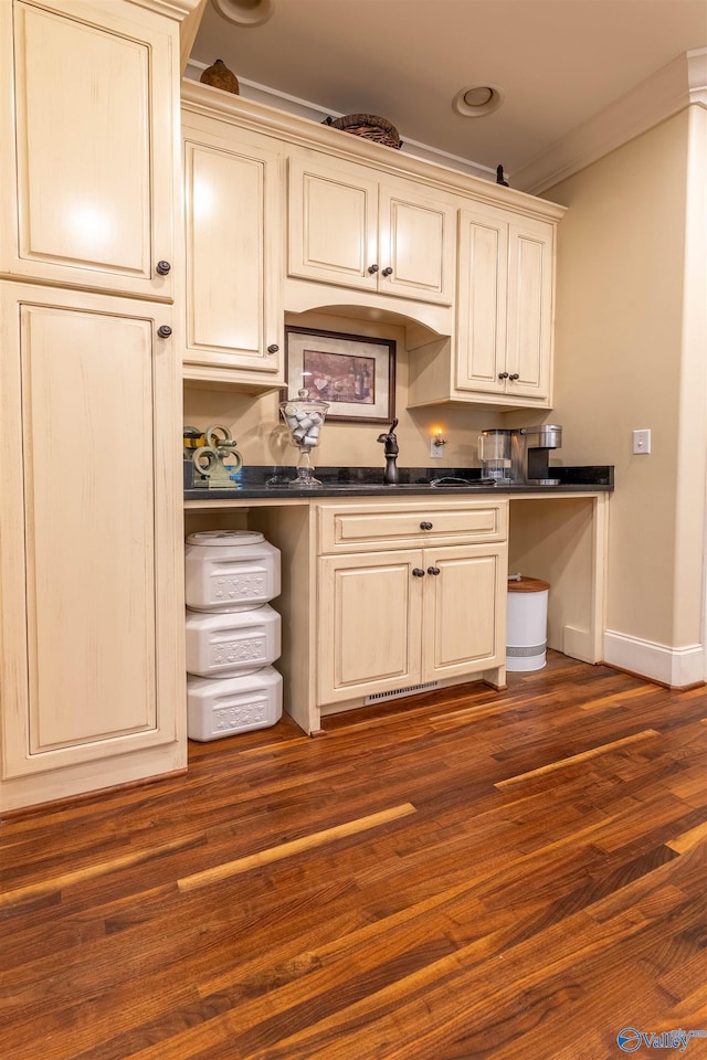 1805 Sibert Dr, Glencoe, AL 35905 - kitchen featuring dark countertops, ornamental molding, baseboards, a sink, and cream cabinetry