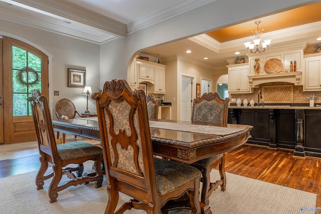 1805 Sibert Dr, Glencoe, AL 35905 - dining room with arched walkways, dark wood-style flooring, a chandelier, ornamental molding, and recessed lighting