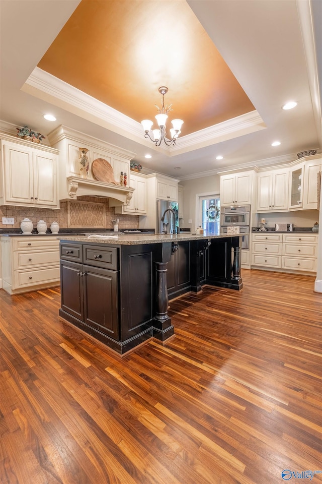 1805 Sibert Dr, Glencoe, AL 35905 - kitchen featuring a raised ceiling, ornamental molding, a chandelier, dark wood-type flooring, and decorative backsplash