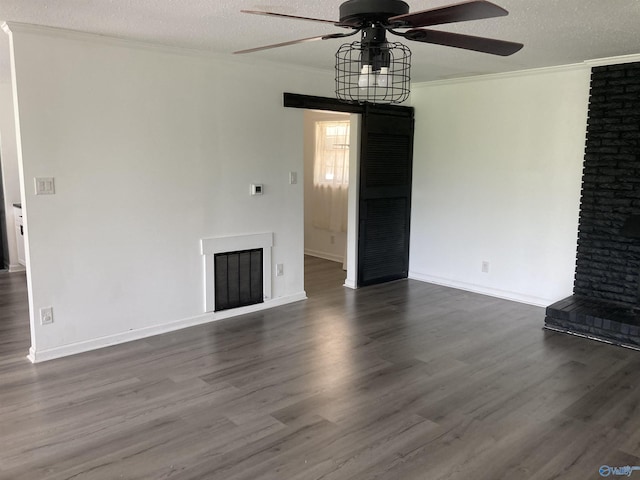 625 S Mountain Dr E, Trinity, AL 35673 - unfurnished living room with a brick fireplace, a textured ceiling, ceiling fan, and ornamental molding