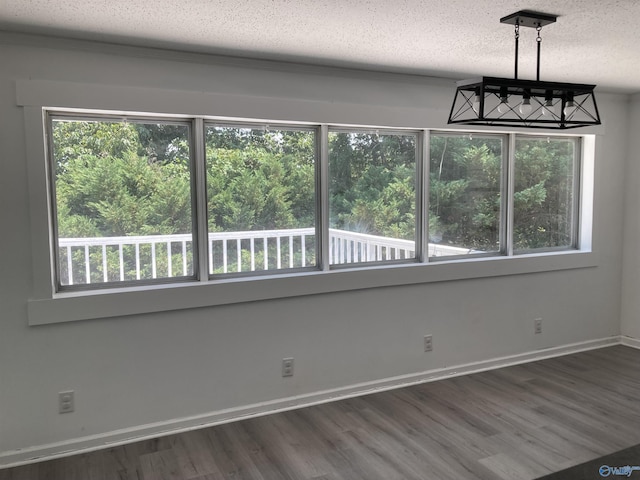 625 S Mountain Dr E, Trinity, AL 35673 - unfurnished dining area with a textured ceiling, baseboards, and wood finished floors