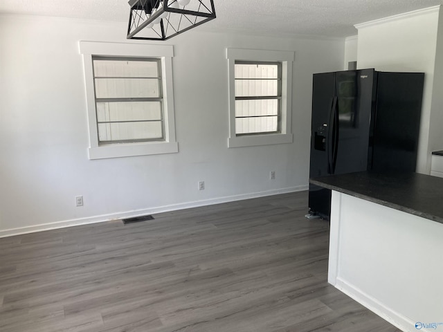 625 S Mountain Dr E, Trinity, AL 35673 - unfurnished dining area with dark wood-type flooring, a textured ceiling, baseboards, and visible vents