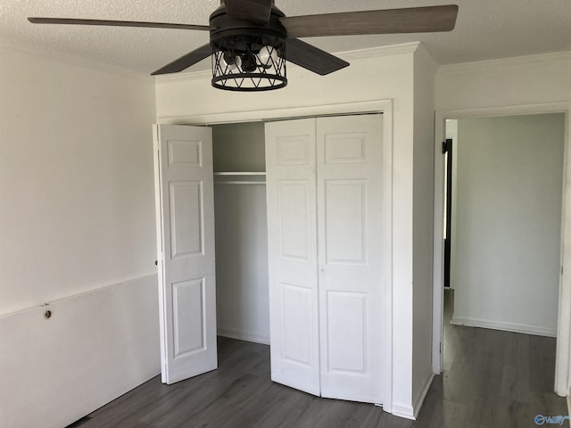 625 S Mountain Dr E, Trinity, AL 35673 - unfurnished bedroom featuring dark wood-type flooring, ornamental molding, a textured ceiling, and a closet