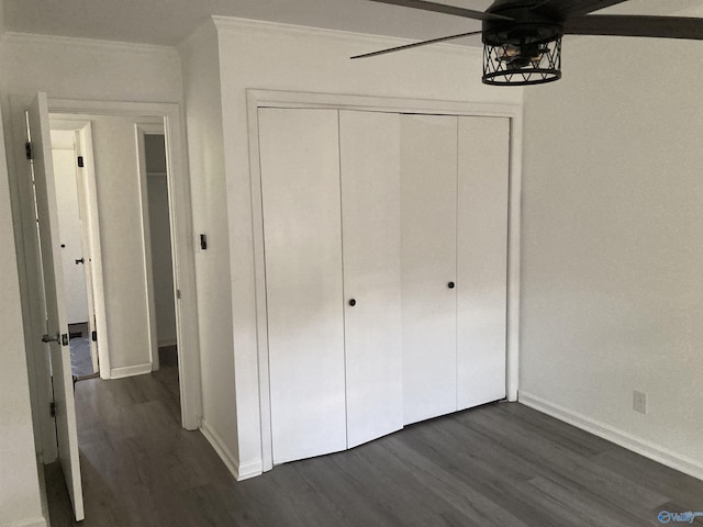 625 S Mountain Dr E, Trinity, AL 35673 - unfurnished bedroom featuring baseboards, dark wood finished floors, crown molding, and a closet