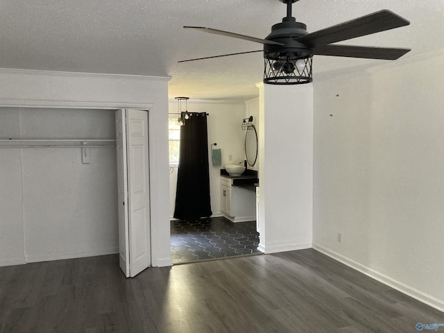 625 S Mountain Dr E, Trinity, AL 35673 - unfurnished bedroom with ceiling fan, ensuite bathroom, a closet, and dark wood-style floors