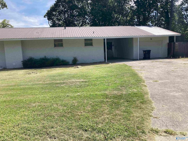 single story home with a carport, a garage, and a front yard