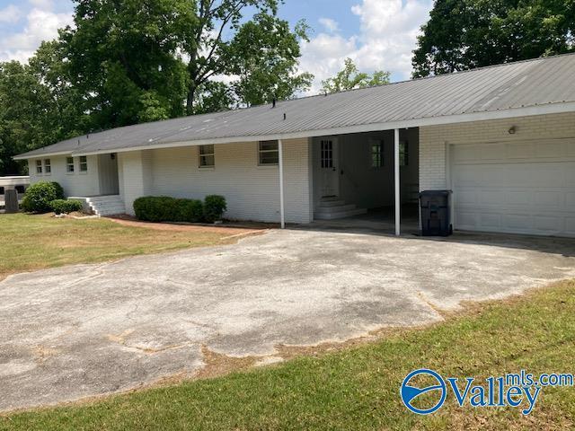 625 S Mountain Dr E, Trinity, AL 35673 - ranch-style home with a front yard, a carport, brick siding, concrete driveway, and entry steps