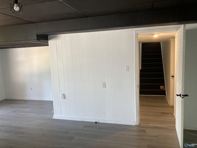 625 S Mountain Dr E, Trinity, AL 35673 - spare room with baseboards, stairs, wood finished floors, and wooden walls