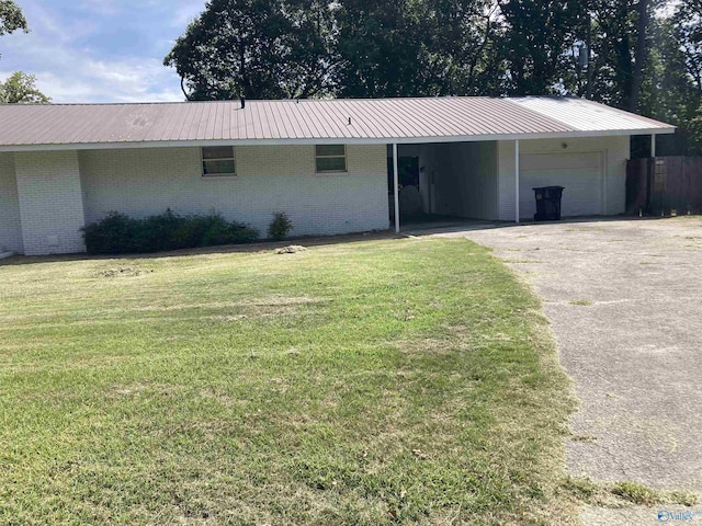 625 S Mountain Dr E, Trinity, AL 35673 - single story home featuring a front lawn, brick siding, metal roof, an attached garage, and driveway