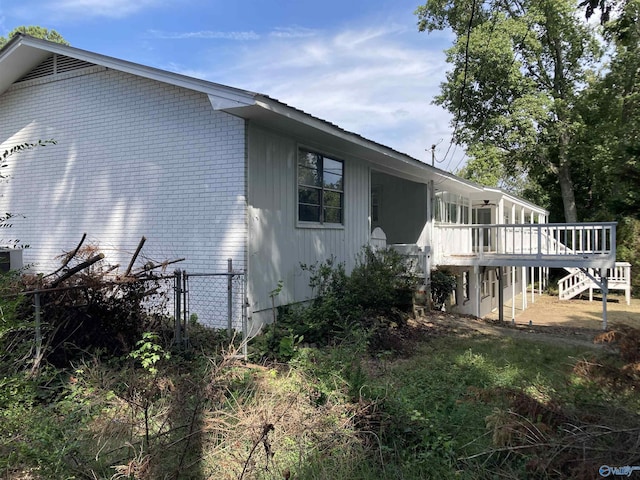625 S Mountain Dr E, Trinity, AL 35673 - view of side of property featuring fence, a wooden deck, and stairs