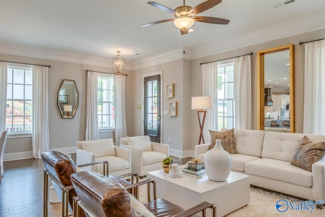 living room with ornamental molding, light hardwood / wood-style floors, and ceiling fan