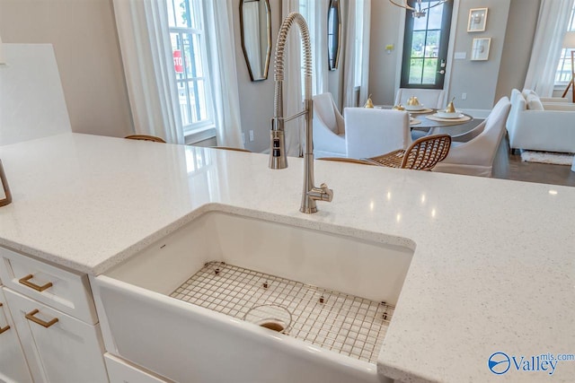 interior details featuring sink and light stone counters