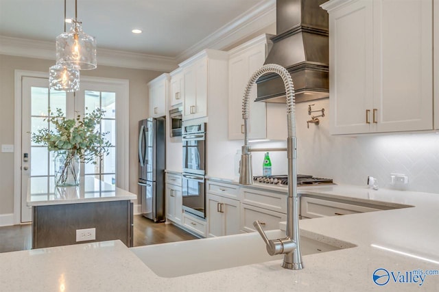 kitchen featuring appliances with stainless steel finishes, light stone countertops, hanging light fixtures, and white cabinetry