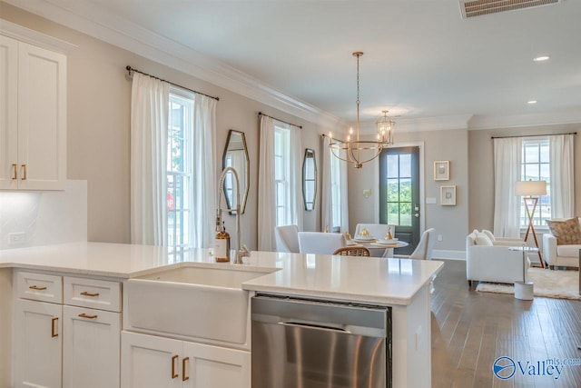 kitchen with a healthy amount of sunlight, stainless steel dishwasher, and white cabinets