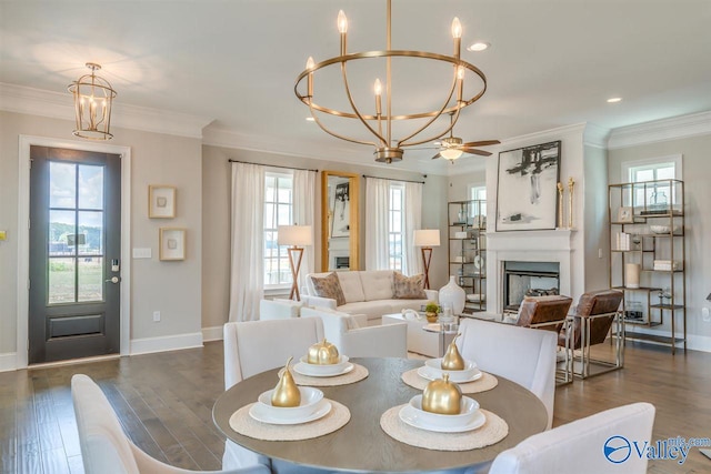 dining room featuring crown molding, a healthy amount of sunlight, and dark wood-type flooring