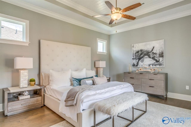 bedroom with hardwood / wood-style floors, crown molding, multiple windows, and ceiling fan