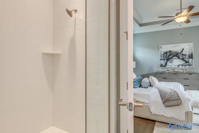 bathroom featuring ornamental molding, ceiling fan, wood-type flooring, and walk in shower