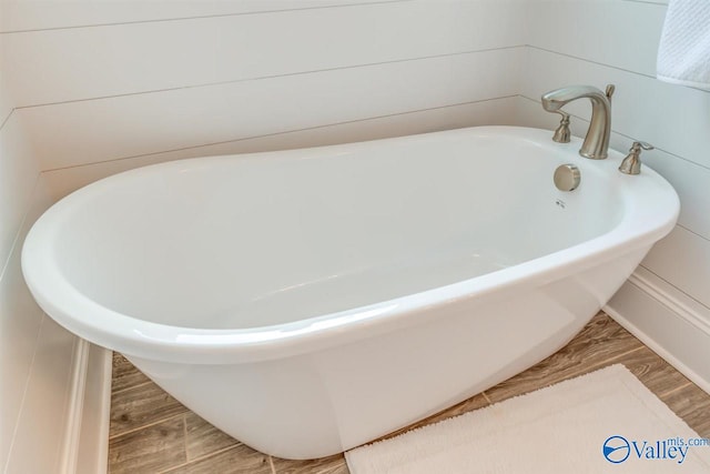 bathroom featuring a bath and wood-type flooring