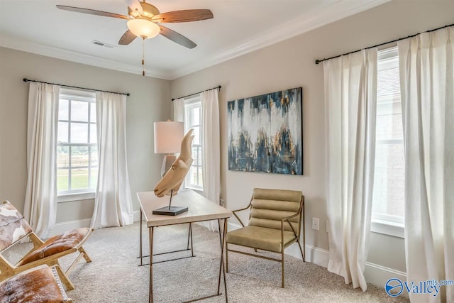 sitting room featuring ceiling fan, crown molding, and light colored carpet