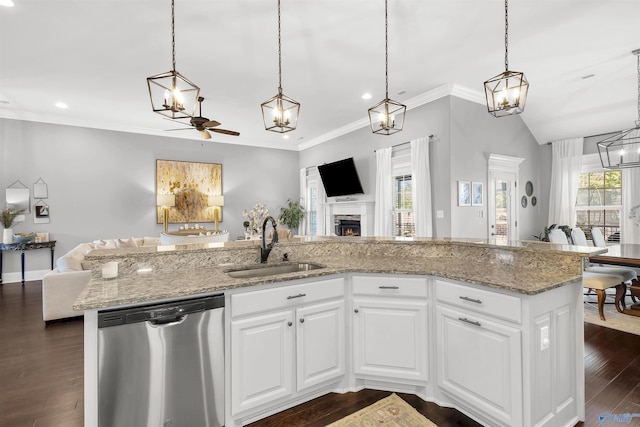 kitchen with stainless steel dishwasher, open floor plan, a sink, and recessed lighting