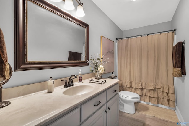 bathroom with toilet, curtained shower, and vanity