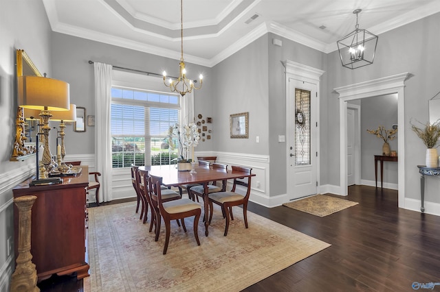dining area with a chandelier, ornamental molding, wood finished floors, and visible vents