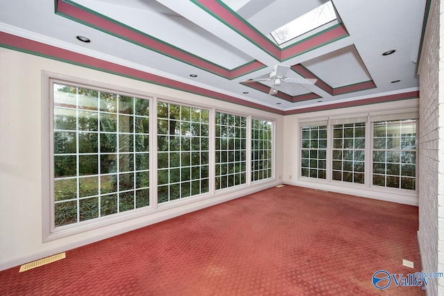 unfurnished sunroom featuring coffered ceiling, ceiling fan, beam ceiling, and a skylight