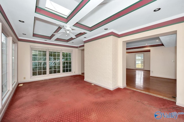 unfurnished living room featuring plenty of natural light, wood-type flooring, ornamental molding, and coffered ceiling