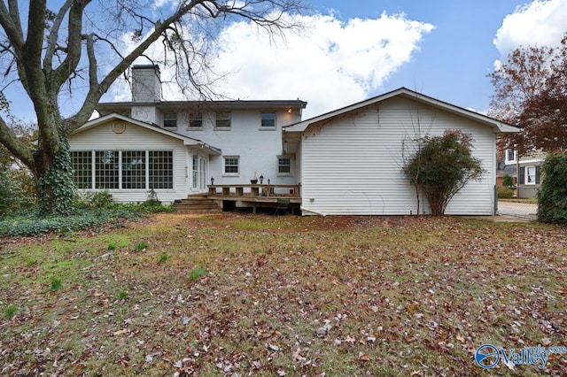 rear view of property featuring a deck