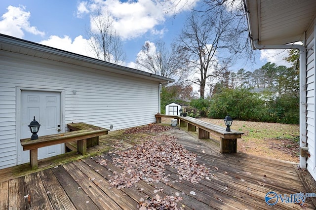 wooden deck featuring a storage unit