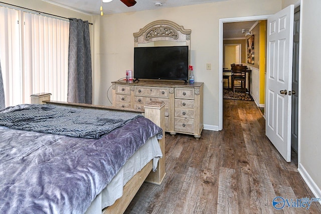 bedroom with baseboards and dark wood finished floors