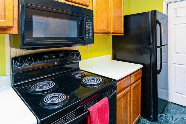 kitchen with light countertops, black appliances, and brown cabinets