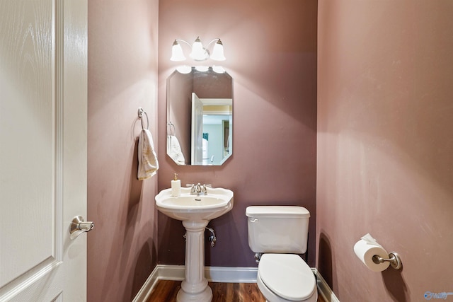 bathroom with toilet and hardwood / wood-style floors