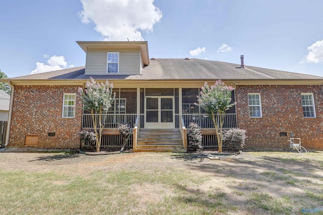 back of house featuring a yard and a wooden deck