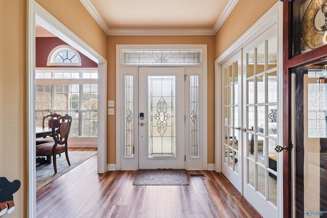 foyer entrance featuring crown molding, french doors, and hardwood / wood-style flooring