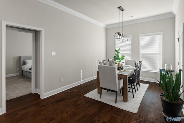 dining area with a notable chandelier, dark hardwood / wood-style flooring, and ornamental molding