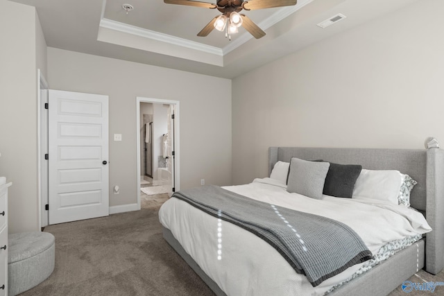 carpeted bedroom with a raised ceiling, ceiling fan, crown molding, and ensuite bathroom