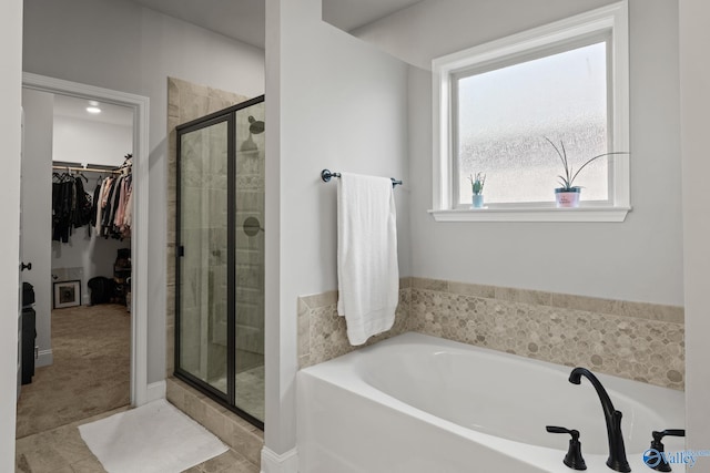 bathroom featuring tile patterned flooring and shower with separate bathtub